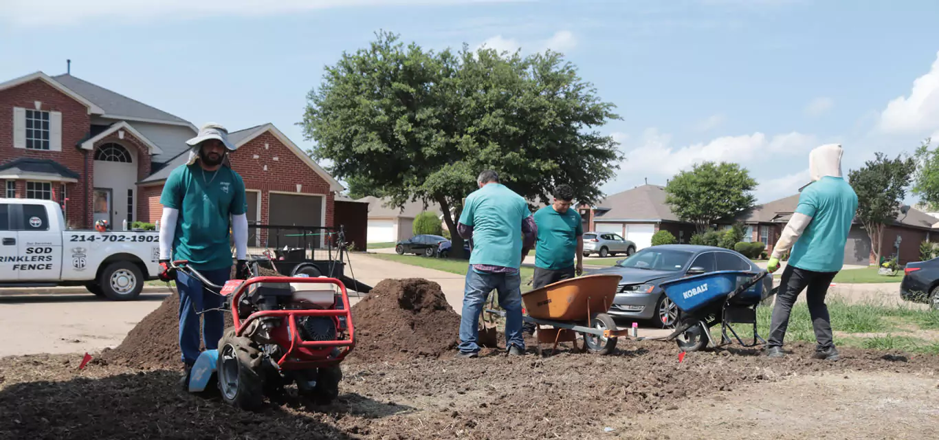 On Point Contractors crew preparing soil for a sod installation project in a residential neighborhood.
