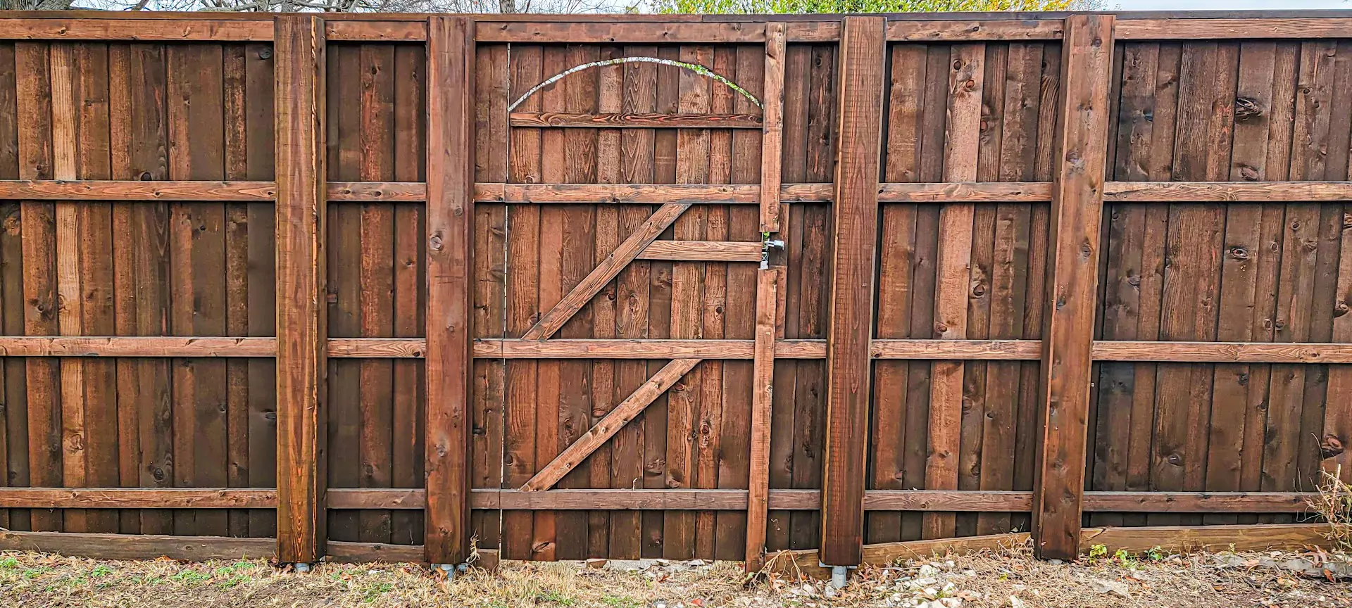 Western Red Cedar 8 ft board-on-board fence with cap and trim, boxed-in steel posts, and cedar 2x4 rails.